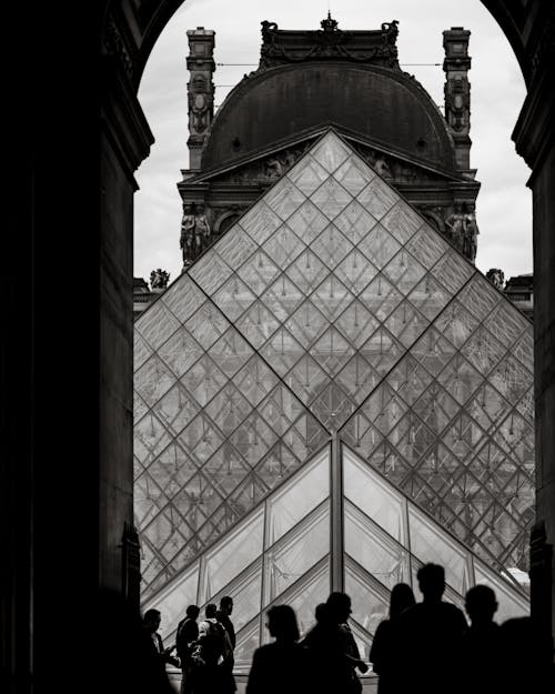 Silhouettes of People Walking near the Louvre Pyramid, Paris, France 
