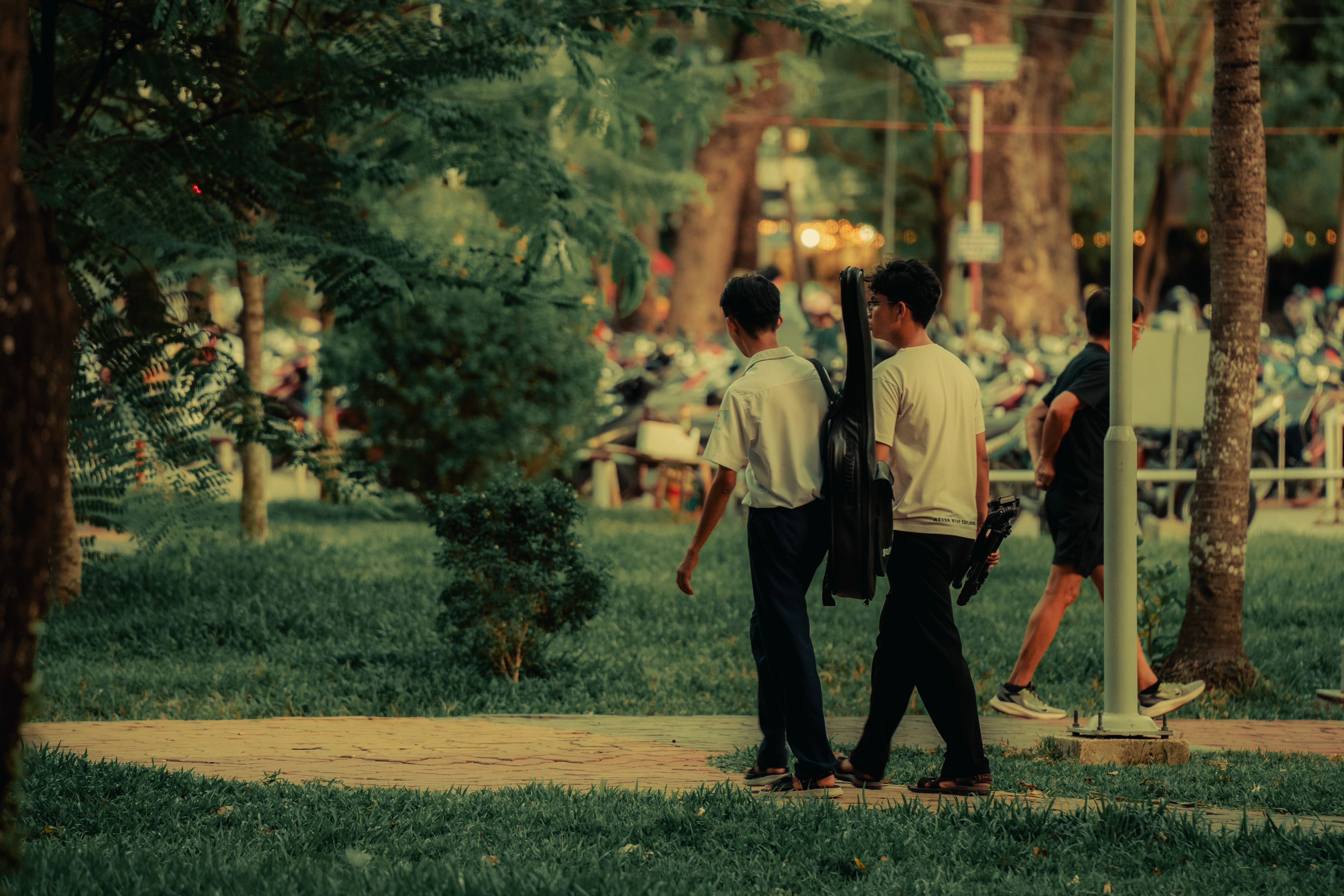 Artist practicing mindfulness in a serene park setting, guitar case by their side.