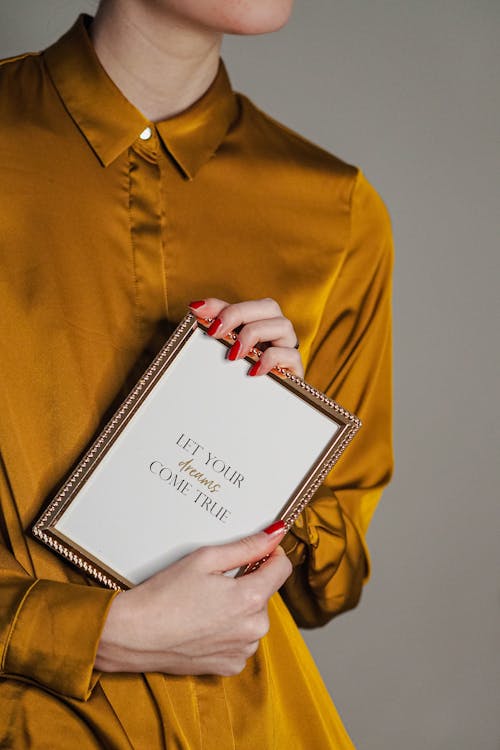 A woman holding a book with the words it's not about you