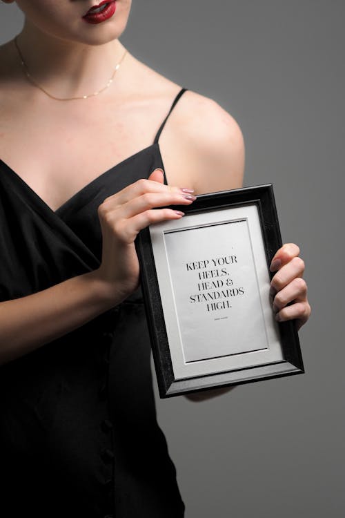 A woman holding a picture frame mockup