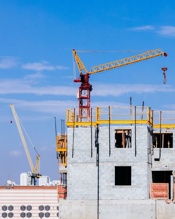 Tower crane on top of a building under construction