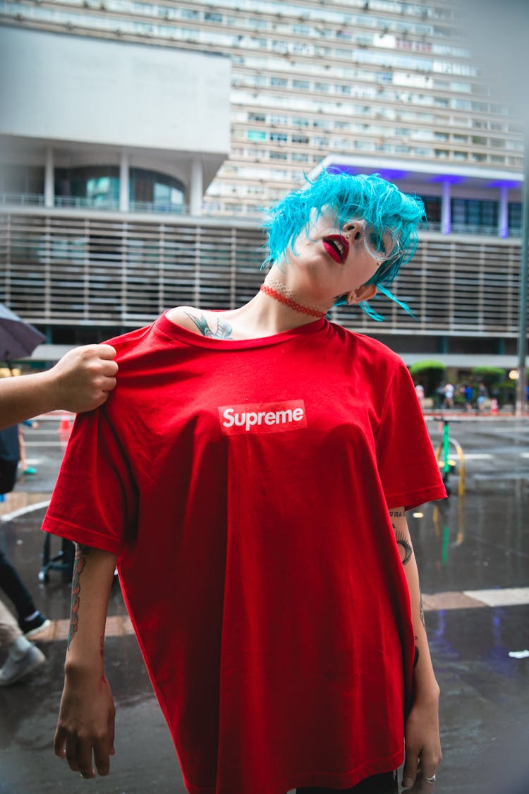 Woman With Teal Hair Wearing Red Supreme Shirt Grab By Person