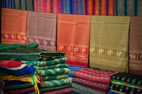 Free A colorful variety of textiles with intricate patterns on display at a market. Stock Photo
