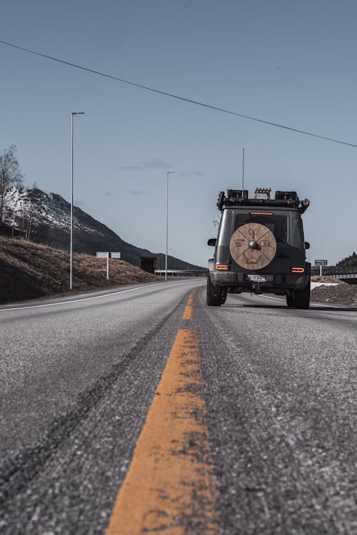 Rear View of a 4x4 Vehicle on a Road · Free Stock Photo
