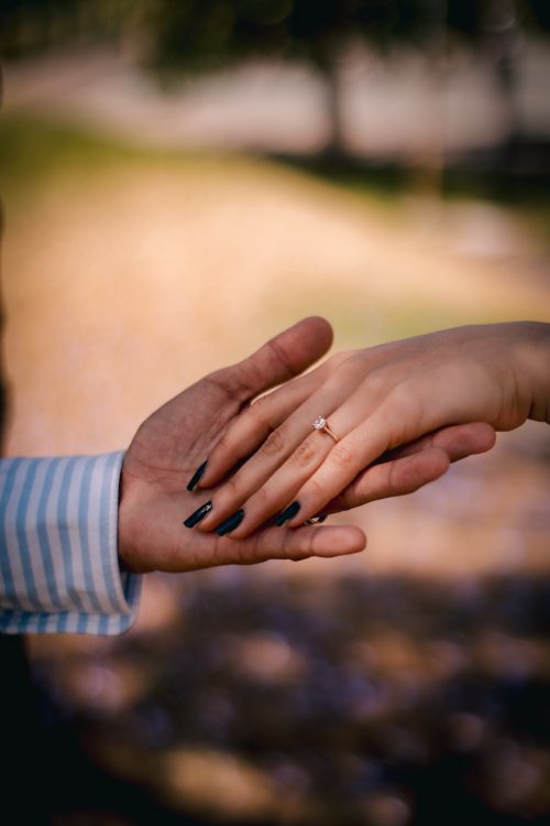 Free Close-up of hands with engagement ring, symbolizing love and commitment. Stock Photo