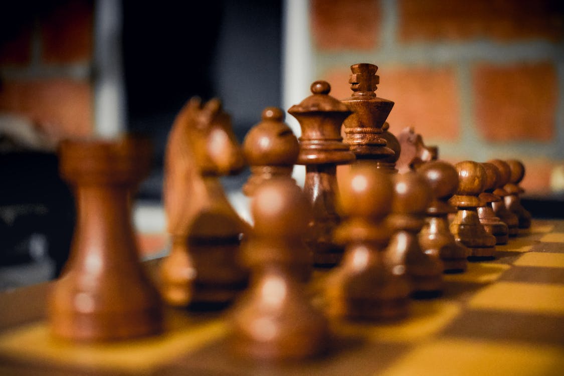 Browse Free HD Images of Chess Pieces In Focus On A Wooden Chess Board