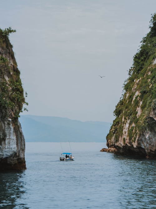 Boat in the Sea Between Mountains