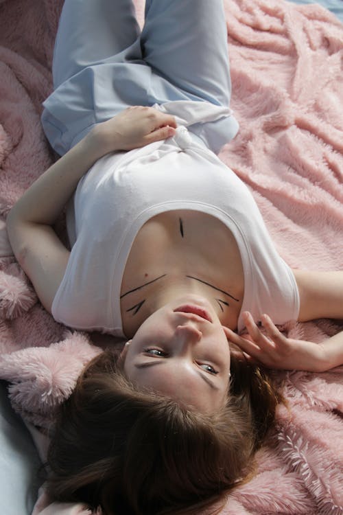 Free A woman lying on a bed Stock Photo