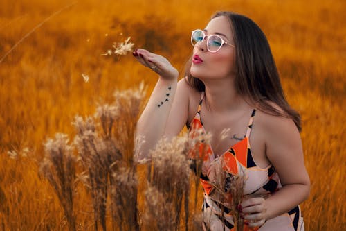 Person Blowing Plant