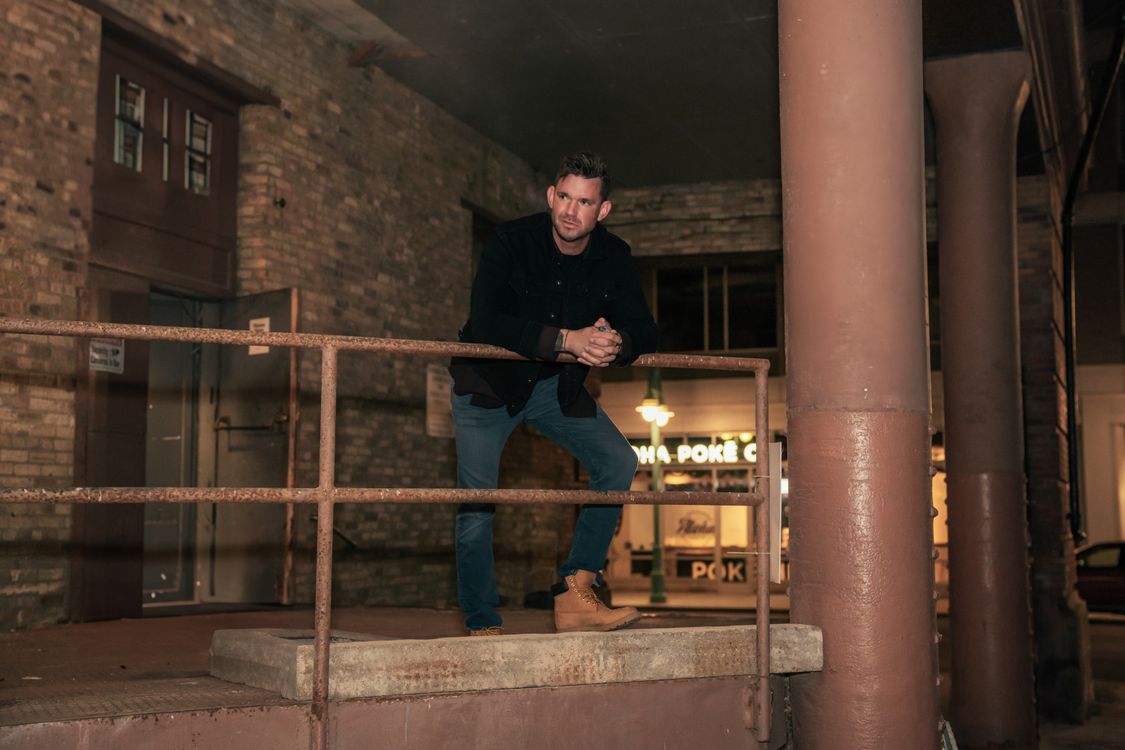 Standing On Railing A man is standing on a railing in an old building · Free Stock Photo