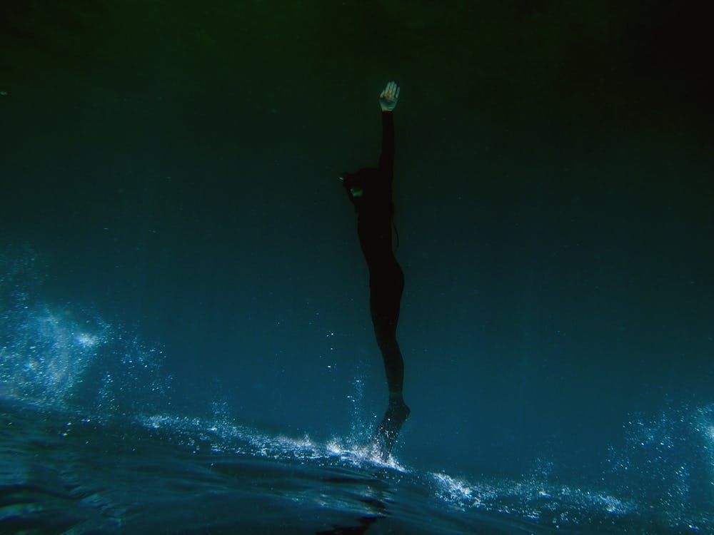 Free Freediver ascending from the depths Stock Photo