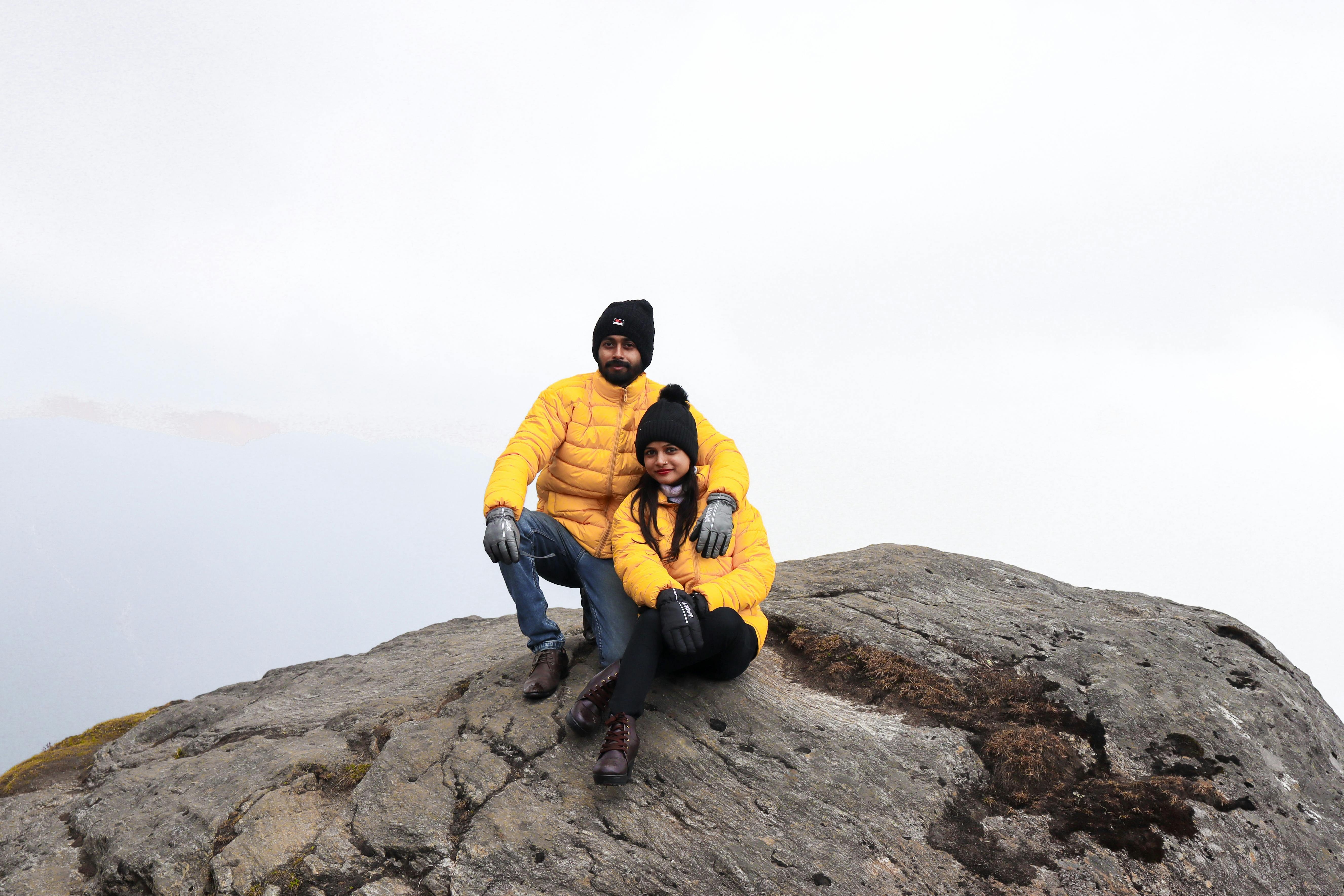 couple sitting on a mountaintop