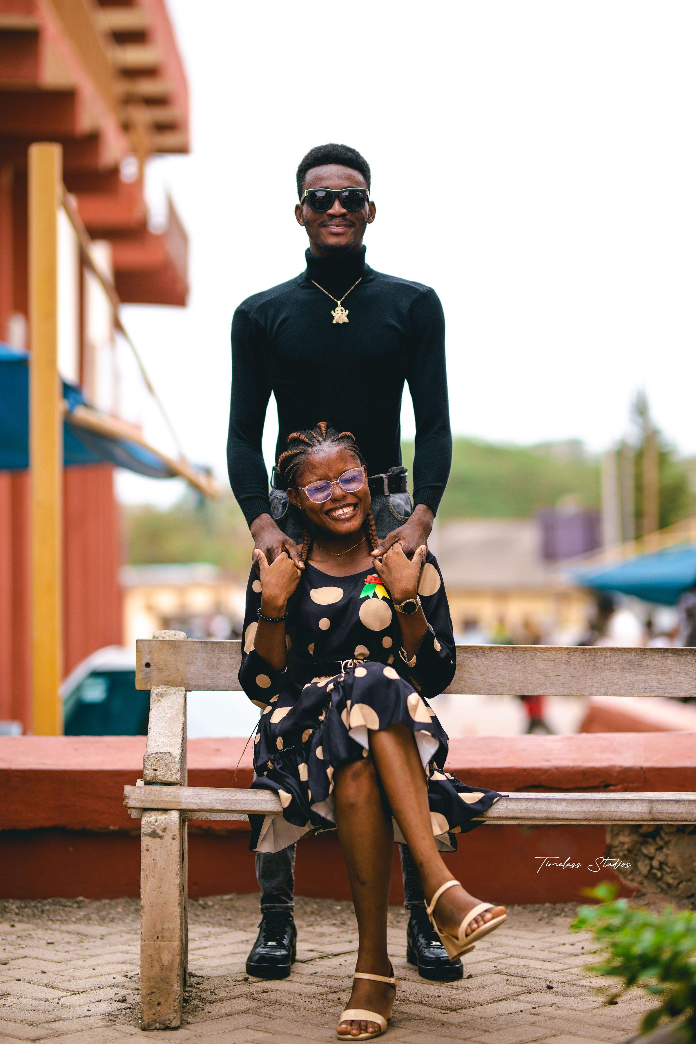 Stylish couple posing outdoors, showcasing fashion and individuality with joy and confidence.