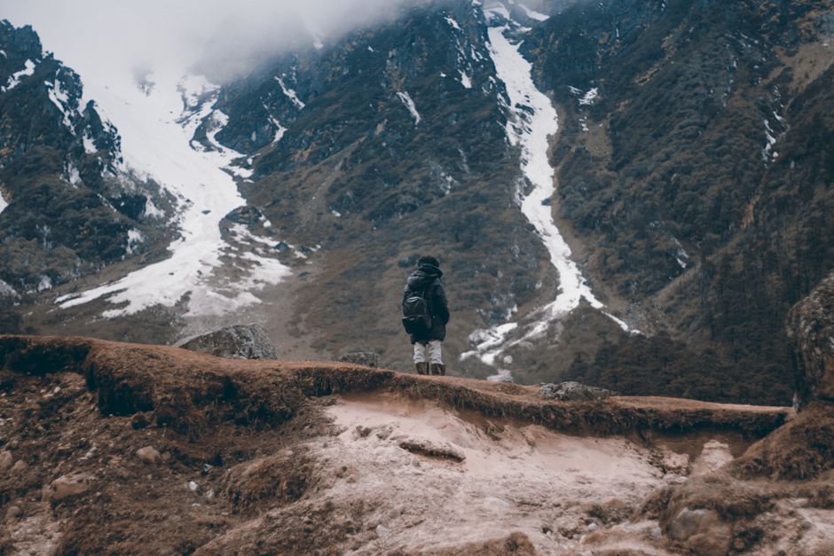 Solo adventurer stands on a rugged ridge in the Himalayan mountains, Gangtok.
