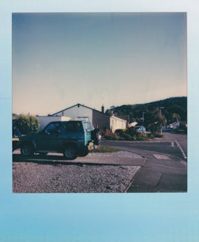 Classic SUV parked in a quiet suburban neighborhood at sunset, with a nostalgic retro vibe.