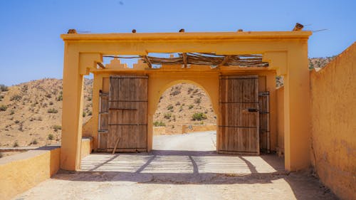 A gate in the desert with a wooden door