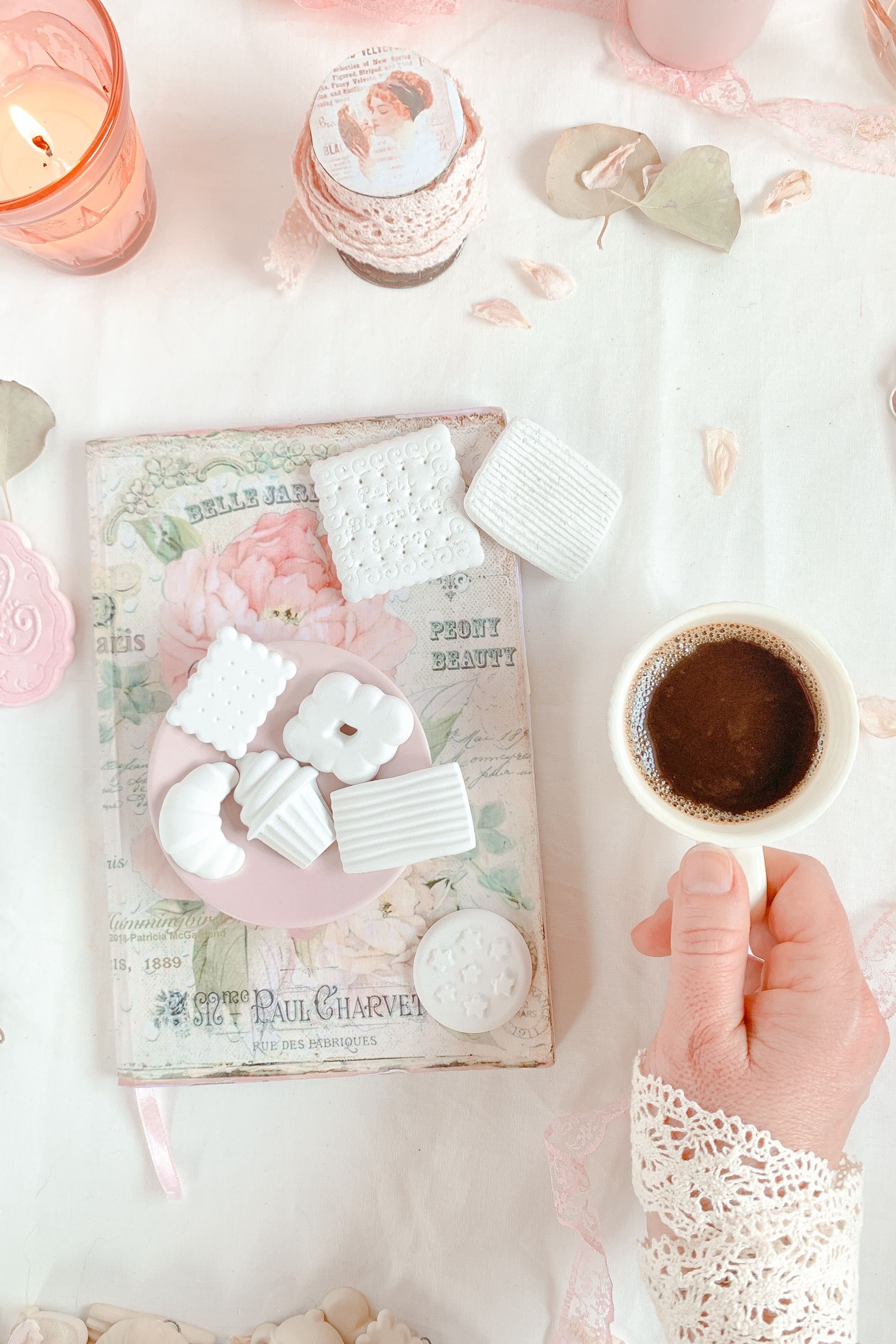 Coffee with marshmallows and book on table