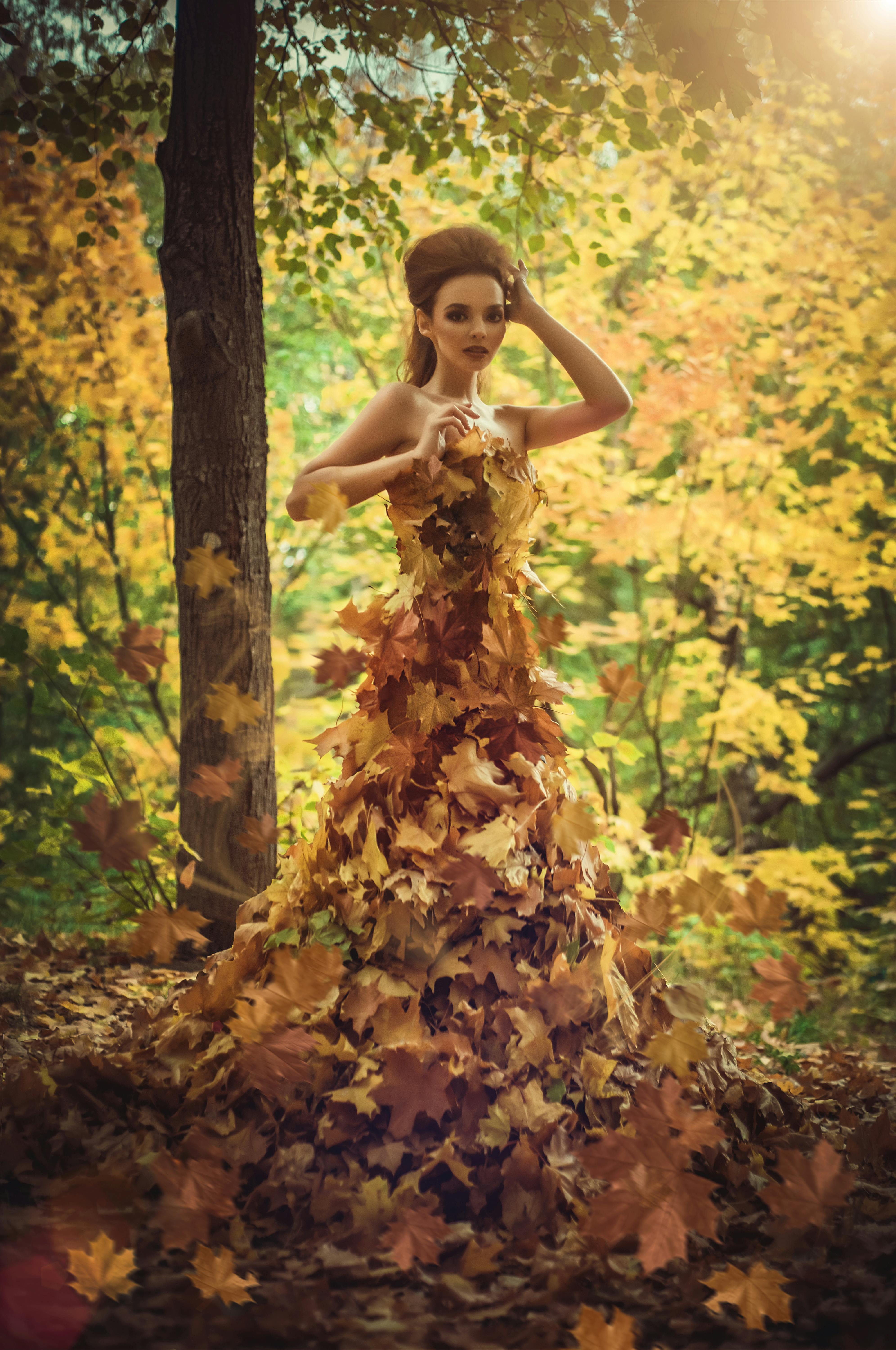 model with autumn leaves as a dress