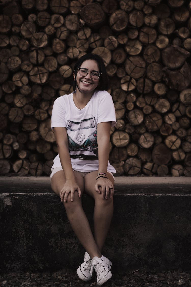 Woman Sitting Near Firewood