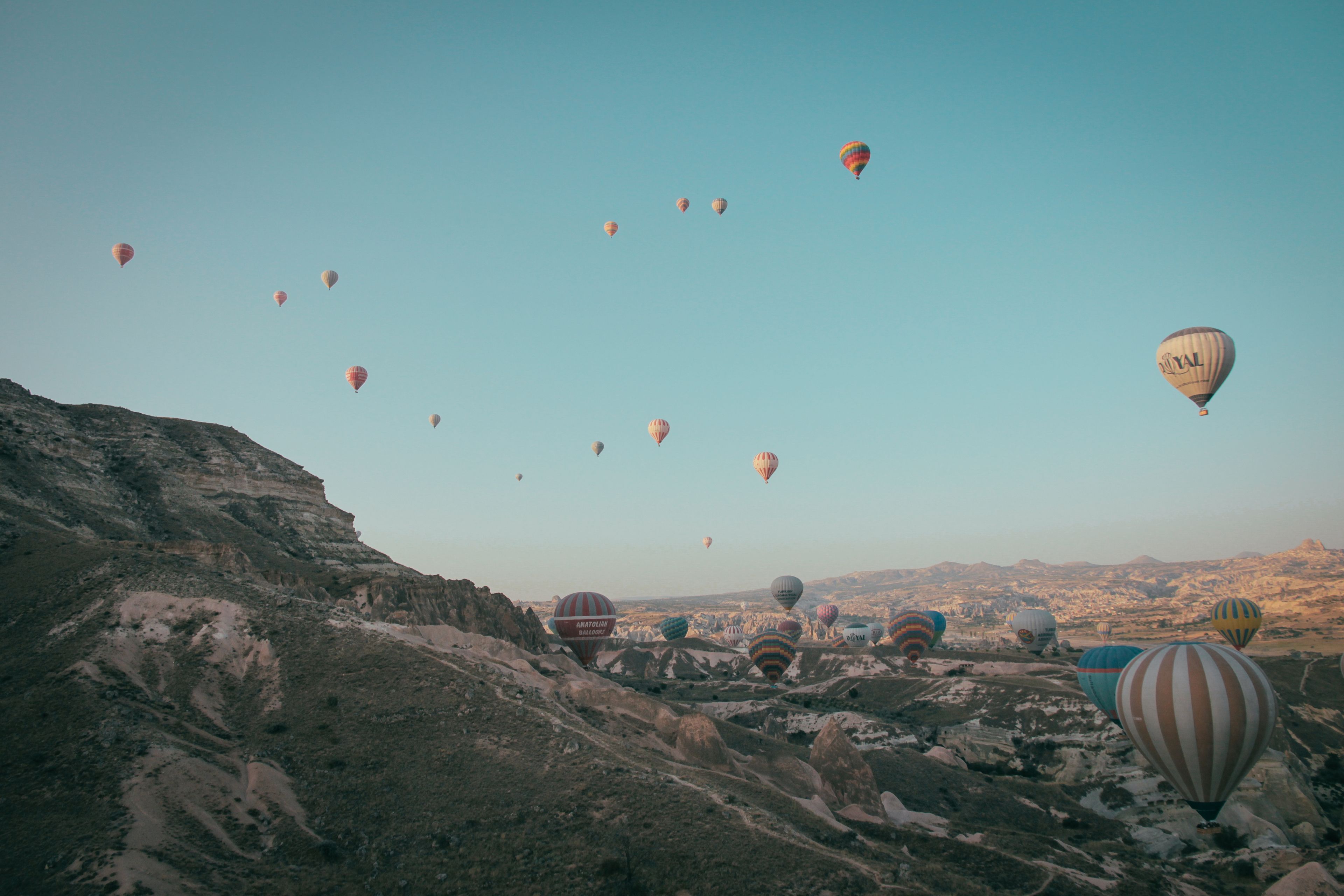 Experience the serene beauty of hot air ballooning over Cappadocia's stunning terrain.