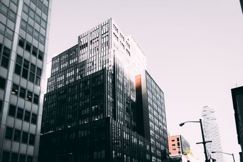 Free A view of modern skyscrapers with glass facades in an urban cityscape during the day. Stock Photo