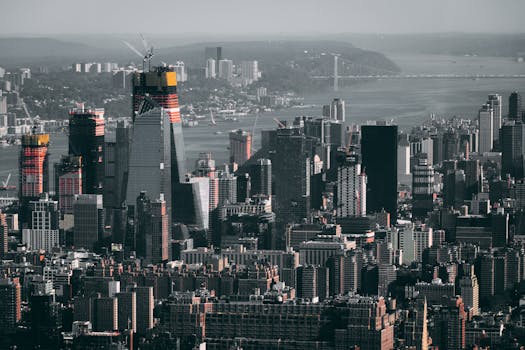 Aerial view of New York City's skyline with towering modern skyscrapers and urban landscape.
