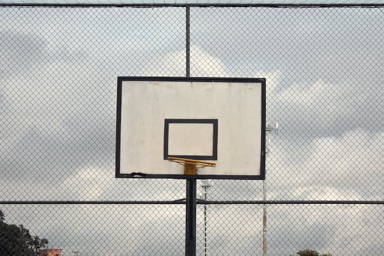 Photo Of Basketball Hoop Near Cyclone Fence