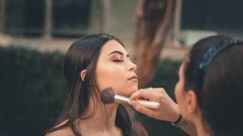 Free woman applying make-up Stock Photo