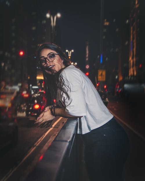 Free Woman in white shirt posing outdoor during night time Stock Photo