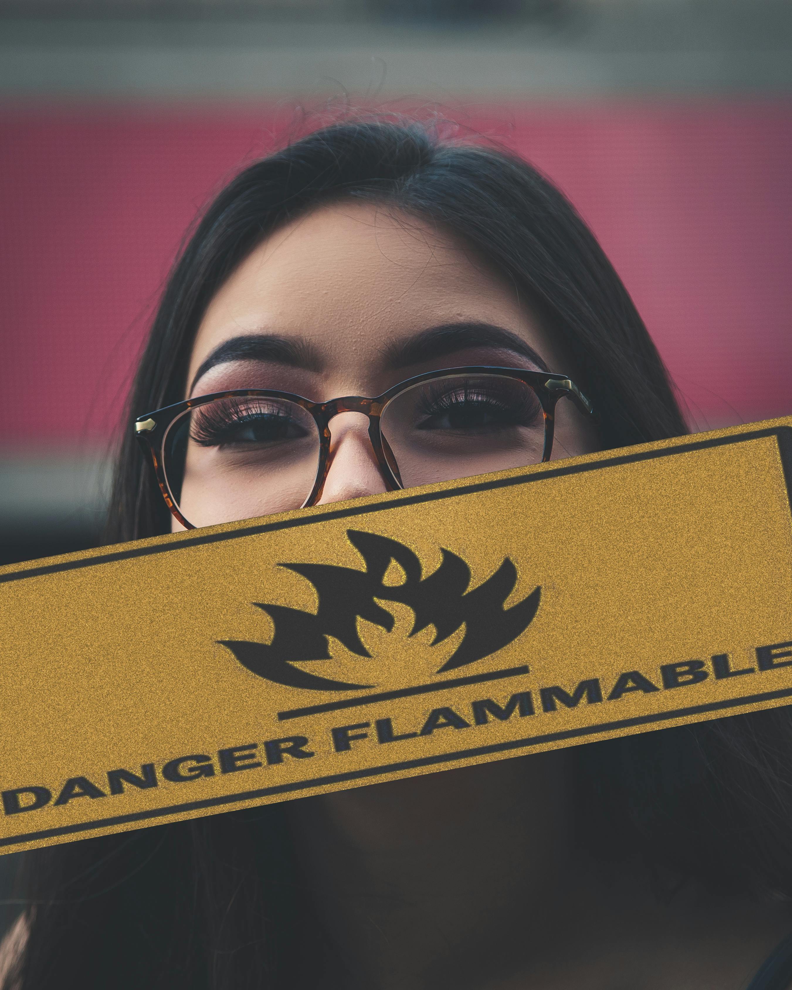 woman holding danger flammable sign