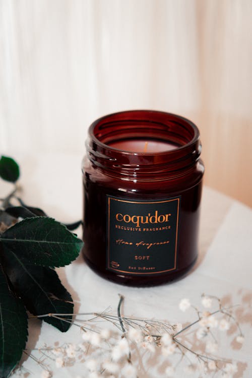 A candle with the words cocoapoo on it