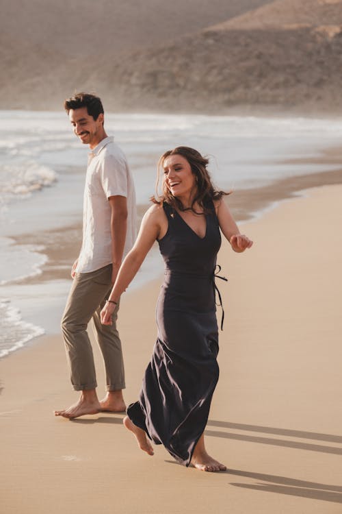 A man and woman walking on the beach together