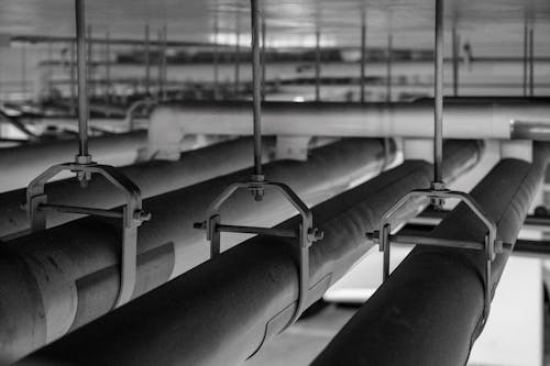 Black and white photo of pipes in a room