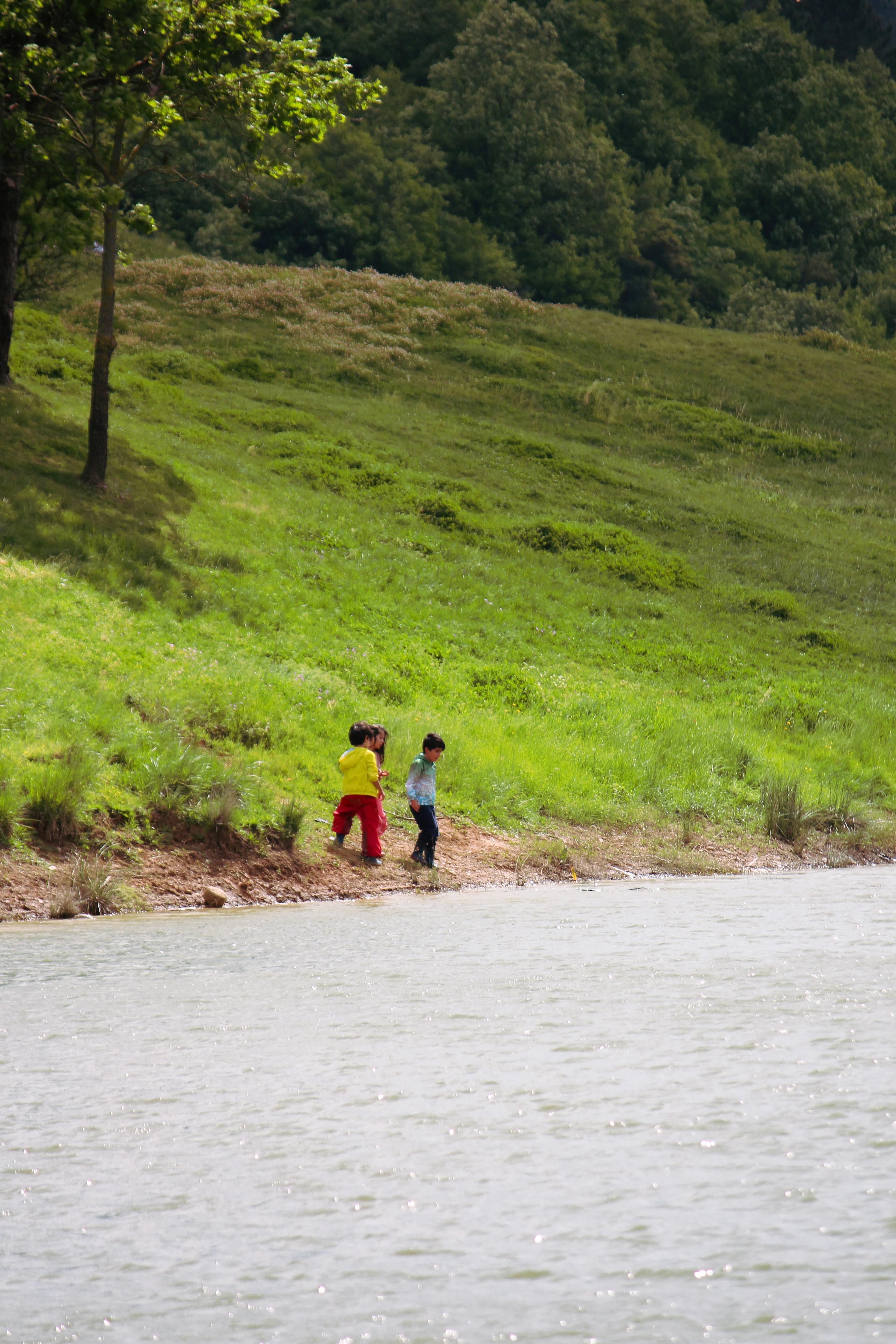 children playing on the steep riverbank