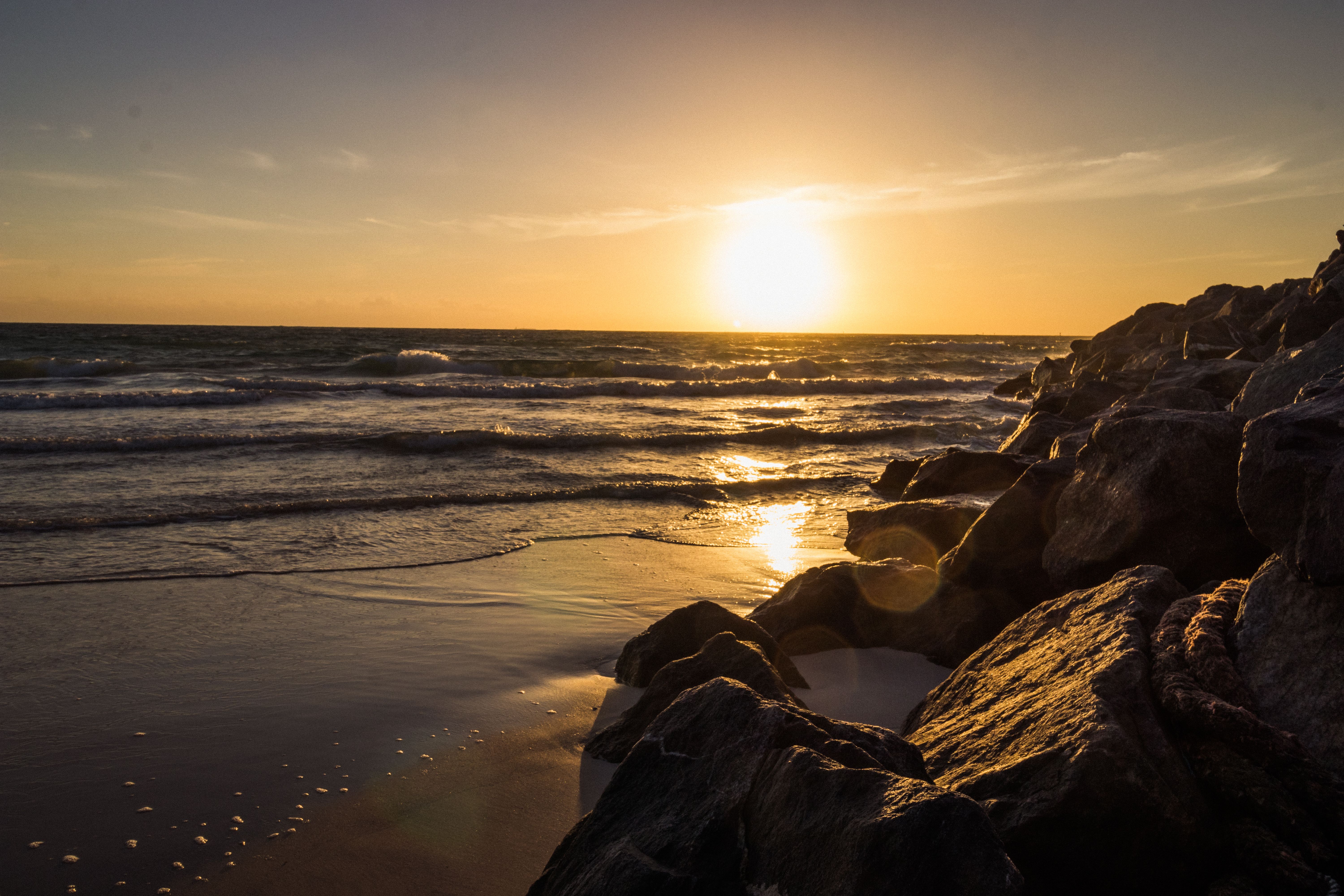 Captivating view of a sunset over the rocky Miami Beach shoreline, Florida.