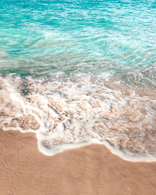 Free Tranquil beachscape with turquoise waves and sandy shore in Australia, perfect for relaxation and summertime vibes. Stock Photo