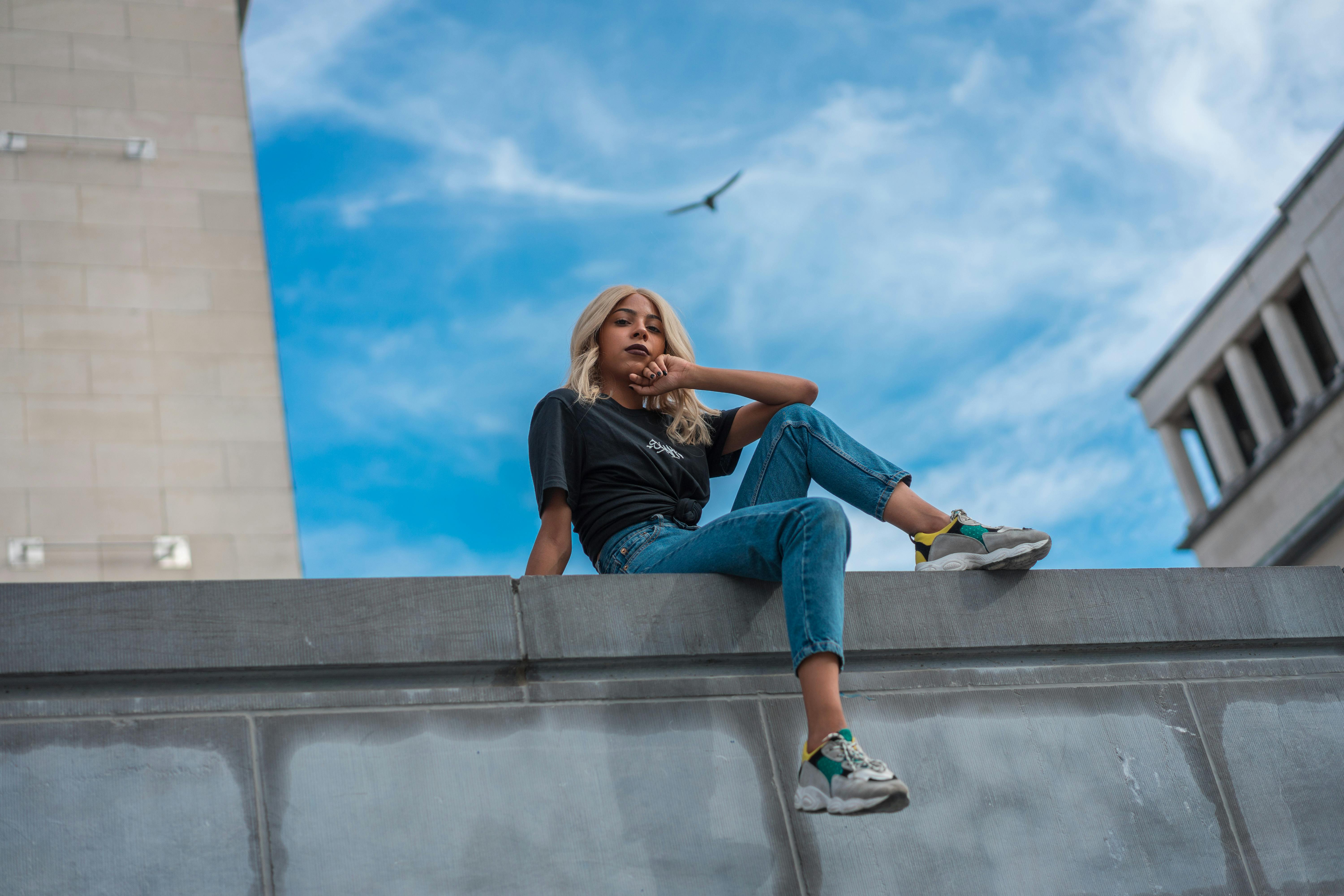 Woman Sitting on Cement · Free Stock Photo