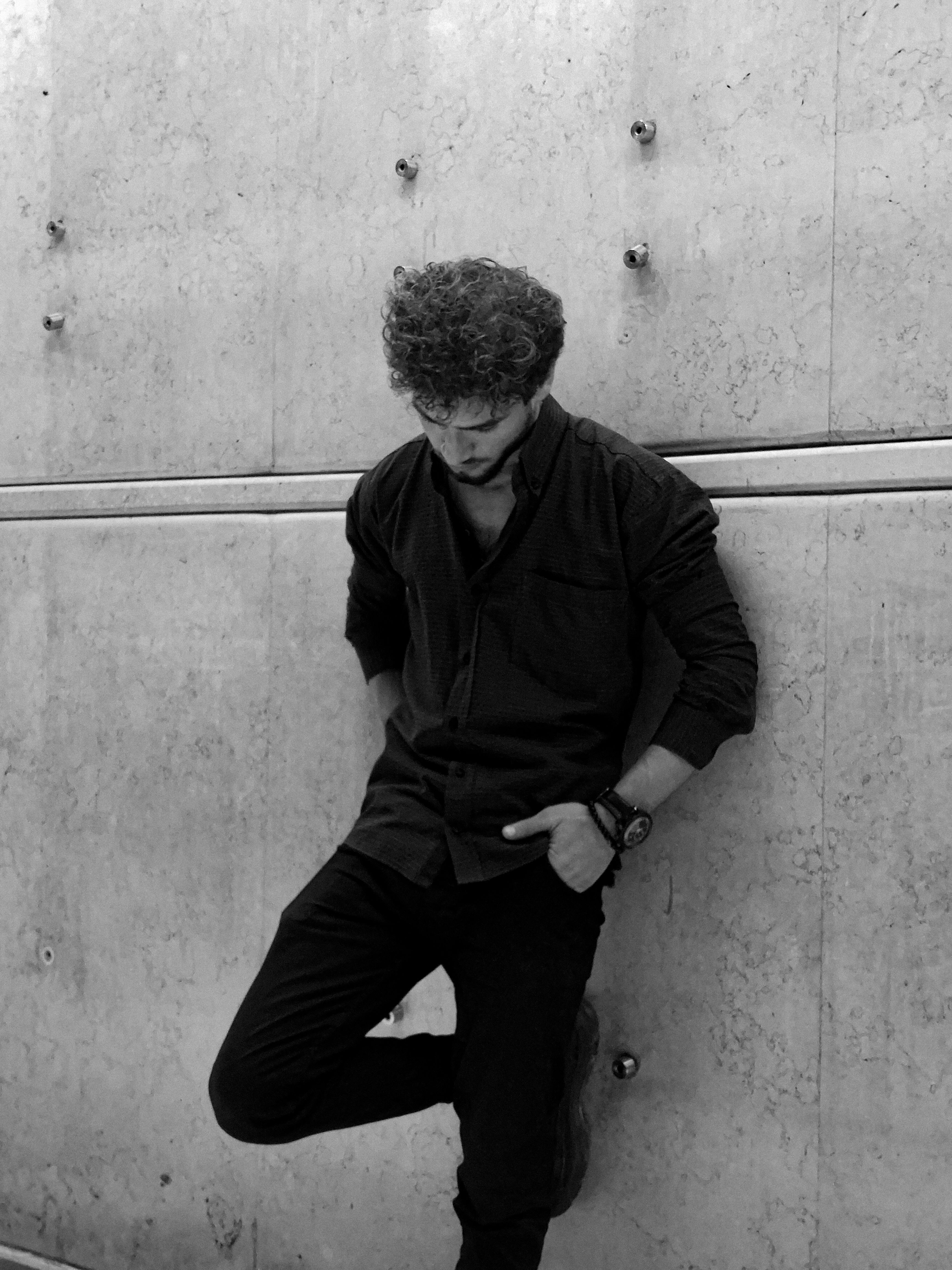 Waiting Man Leaning Against Concrete Wall · Free Stock Photo