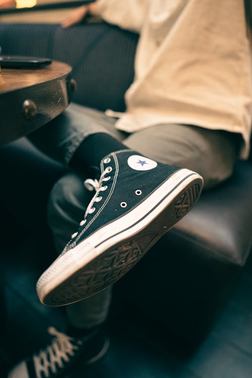 A person sitting on a table with their feet on the floor