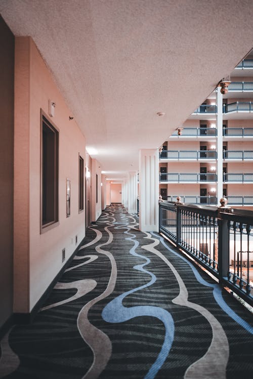 A hallway with carpet and blue and black pattern