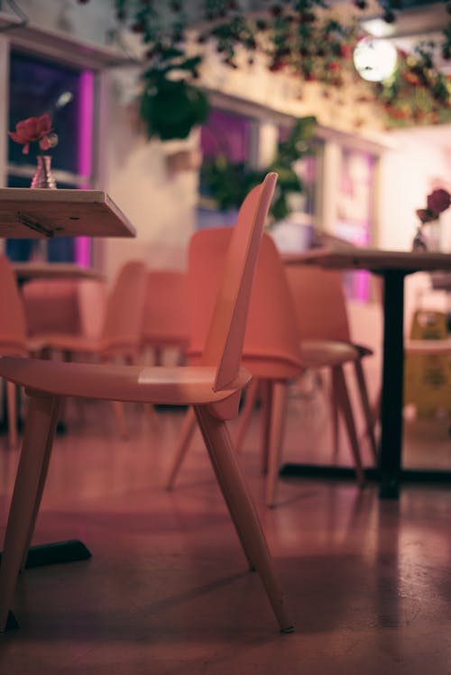 A pink chair and table in a restaurant