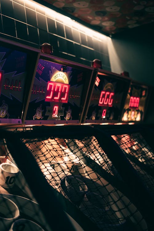 A row of arcade games with lights on them