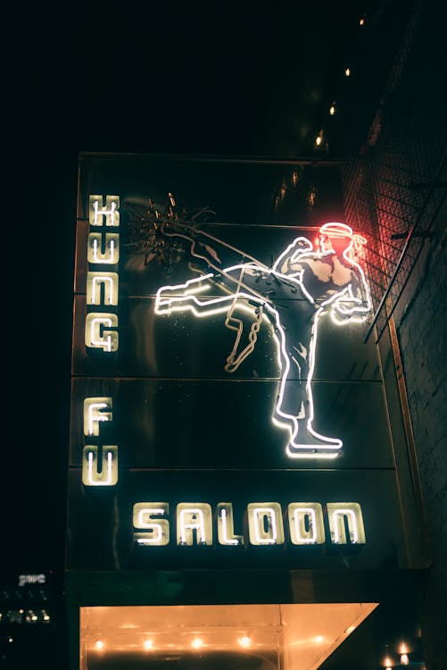 A neon sign for king fu saloon in the city