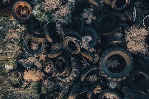 A pile of tires in the middle of a field