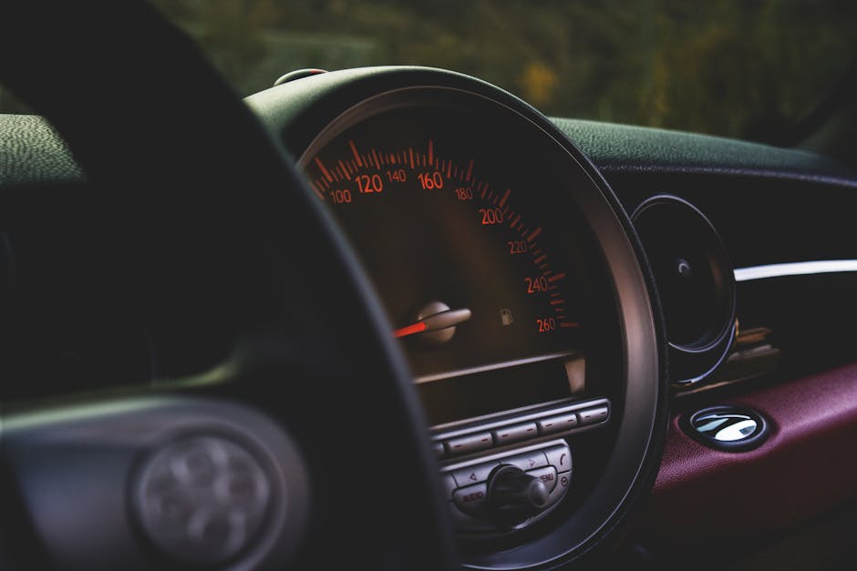 Focused view of a car's speedometer and dashboard with a luxury feel.