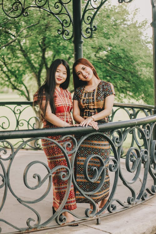 Two Smiling Women Standing Next to Each Other