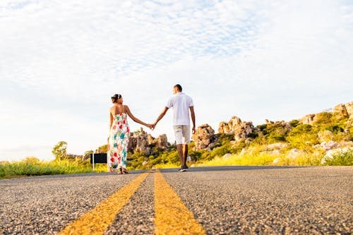 Couple holding hands on mountain road