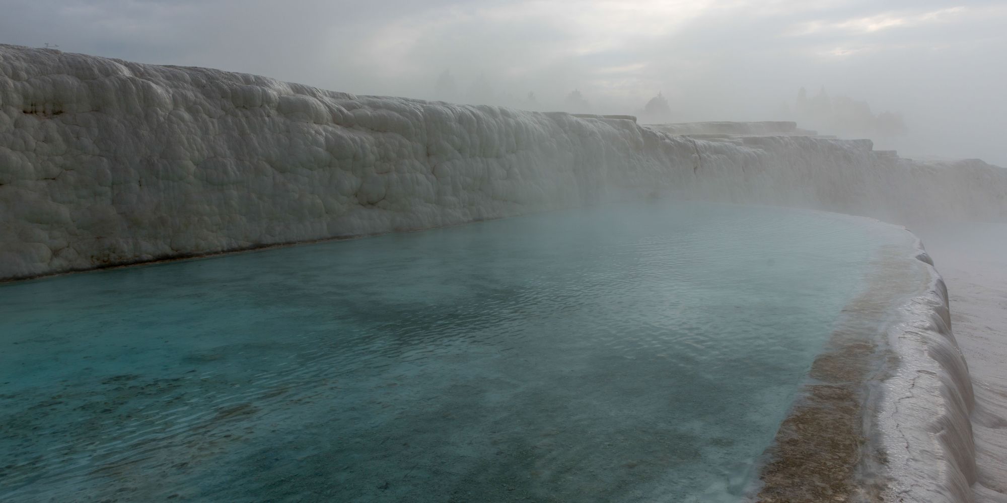 Steam drifting off the surface of a warm mineral pool