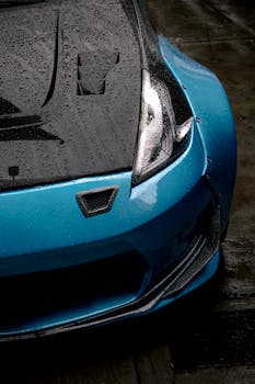 Detailed view of a blue sports car with raindrops in Santiago de Querétaro, Mexico.
