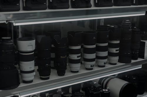 A shelf full of camera lenses and other equipment